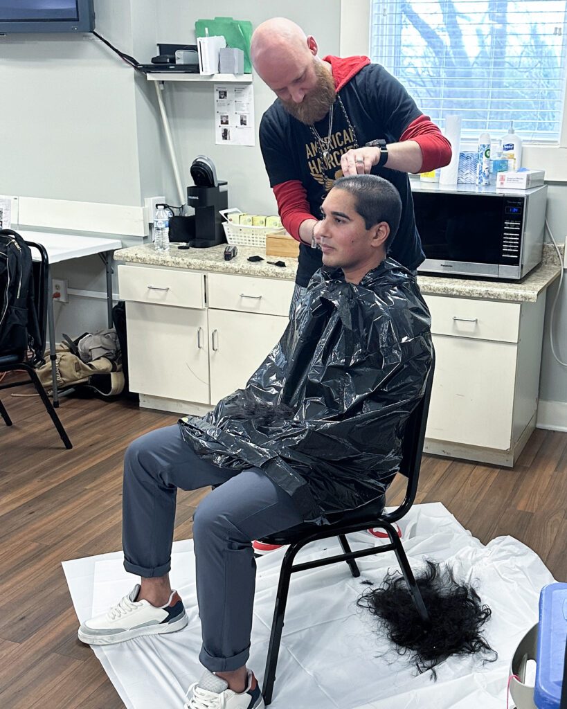 Chris the Barber, shaving Parag's hair